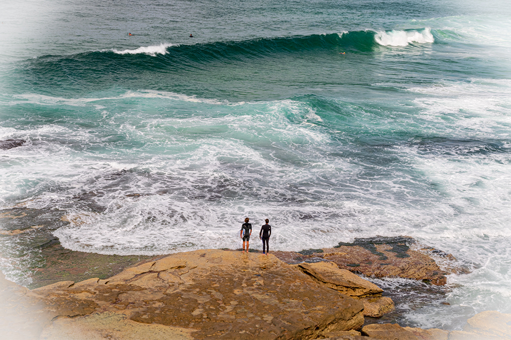 Surfers gazing at surf